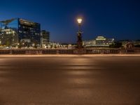 the city skyline is at night from the street level with traffic and pedestrians walking on it