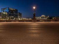 the city skyline is at night from the street level with traffic and pedestrians walking on it