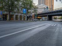 a city street that has a bridge over the road at sunset on a clear day