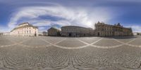 an upside down photograph of the square with a sky background and clouds around it and people walking by the side