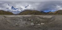 the camera is positioned in front of a big mountain range with low mountains in the background