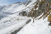 a person on a snow board rides down the slope on a snowy mountain with a mountain