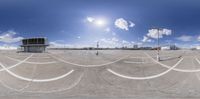 a skate park with various white painted lines and people riding skateboards on the pavement