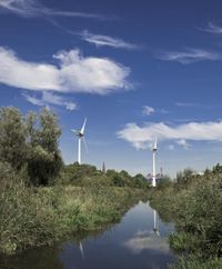 European Landscape: Windmill by the River in Coastal Germany
