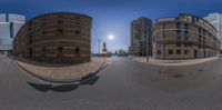 a photo taken by a fisheye lens with buildings and road in the background,