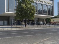 a street view of a modern, multi - story, building with a restaurant on the corner