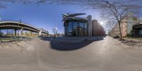 a fish eye view of a street with an old looking building in the background in a city