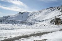 there is snow everywhere in the mountains of the region, on which a glacier is melting