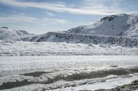 there is snow everywhere in the mountains of the region, on which a glacier is melting