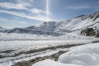 there is snow everywhere in the mountains of the region, on which a glacier is melting