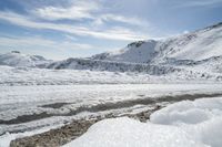 there is snow everywhere in the mountains of the region, on which a glacier is melting