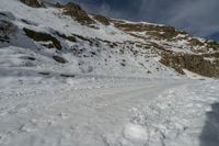 some people are hiking on a snowy hill and one person is looking out into the distance