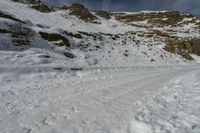 some people are hiking on a snowy hill and one person is looking out into the distance