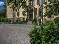 large yellow building with some plants and bushes in front of it for decoration or entertainment