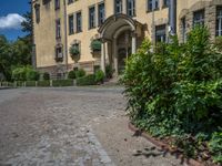 large yellow building with some plants and bushes in front of it for decoration or entertainment