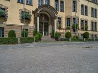 large yellow building with some plants and bushes in front of it for decoration or entertainment