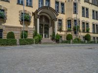 large yellow building with some plants and bushes in front of it for decoration or entertainment