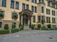 large yellow building with some plants and bushes in front of it for decoration or entertainment