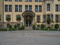 large yellow building with some plants and bushes in front of it for decoration or entertainment