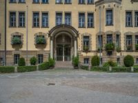 large yellow building with some plants and bushes in front of it for decoration or entertainment