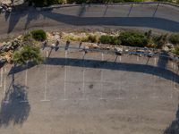 an overhead view of a basketball court and tennis courts near mountains in california with shadows