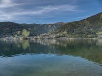 this is a view of a body of water with mountains and a boat docked on it