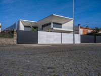 this large house has two terraces that surround it and the garage is closed to the street