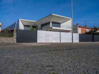 this large house has two terraces that surround it and the garage is closed to the street