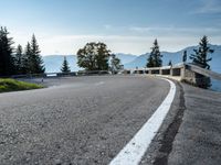 a person is riding on the side of a mountain road and holding a bike in the air