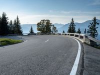 a person is riding on the side of a mountain road and holding a bike in the air