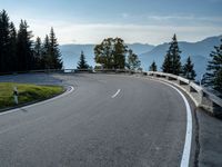 a person is riding on the side of a mountain road and holding a bike in the air