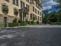 large yellow building with some plants and bushes in front of it for decoration or entertainment