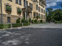 large yellow building with some plants and bushes in front of it for decoration or entertainment