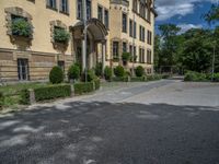 large yellow building with some plants and bushes in front of it for decoration or entertainment