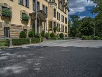 large yellow building with some plants and bushes in front of it for decoration or entertainment