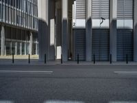 the empty street with bicycles parked in front of the buildings has a sign that says the library on it