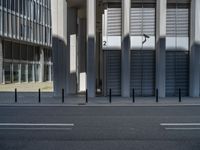 the empty street with bicycles parked in front of the buildings has a sign that says the library on it