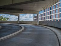 a car is driving on the highway through an underground parking garage area in a city