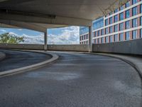 a car is driving on the highway through an underground parking garage area in a city