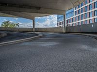 a car is driving on the highway through an underground parking garage area in a city