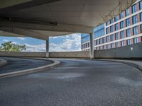 a car is driving on the highway through an underground parking garage area in a city