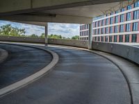 a car is driving on the highway through an underground parking garage area in a city