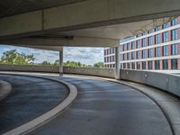 a car is driving on the highway through an underground parking garage area in a city