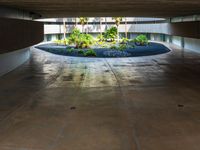 a parking garage with a circular parking area in the center with lots of plants growing on it