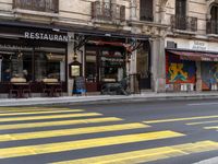 some shops are on the side of the street in paris, france, while a taxi is parked nearby