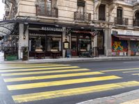 some shops are on the side of the street in paris, france, while a taxi is parked nearby