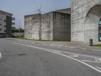 an empty street with the graffiti on it's side and a sidewalk on the other side