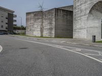 an empty street with the graffiti on it's side and a sidewalk on the other side