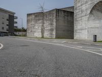 an empty street with the graffiti on it's side and a sidewalk on the other side