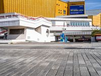 a white building that has a sign at the top of it with a small car